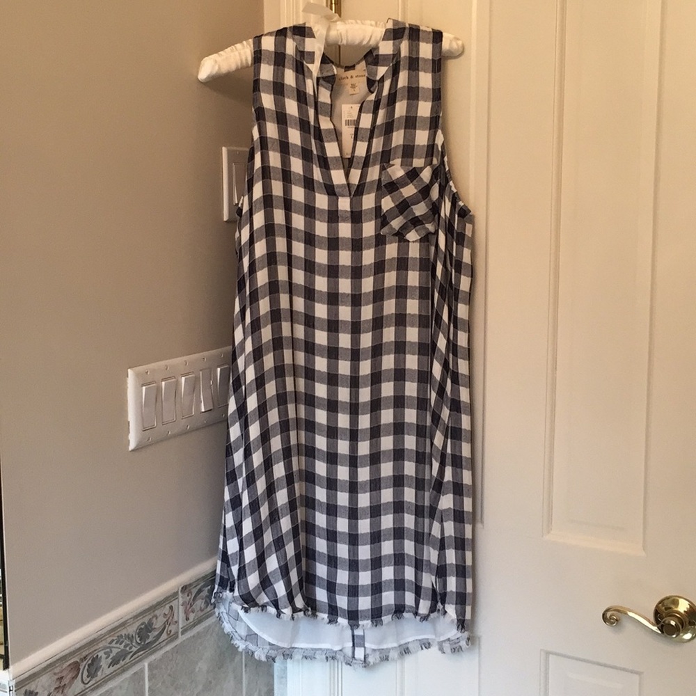 Lined sleeveless dress; buttons down the back.
